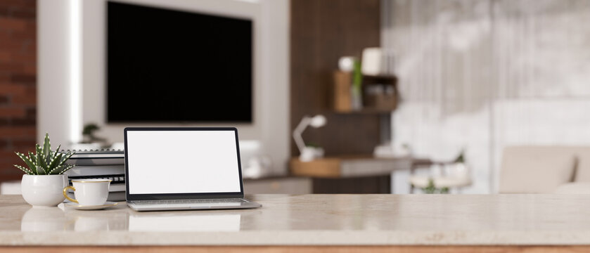 Laptop mockup and copy space on white marble tabletop against blurred background of living room