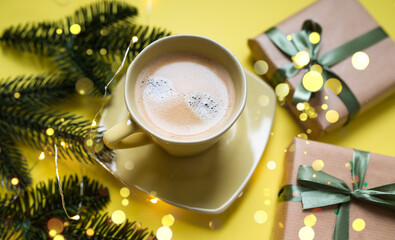 
cozy new year layout with a cup of coffee and new year decorations and christmas lights on a...