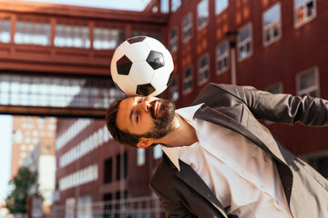 Image of a businessman and soccer freestyle player making tricks with the ball on the street....
