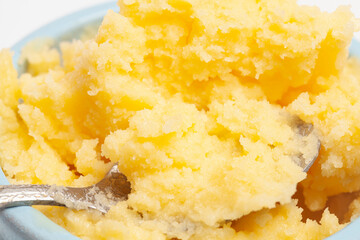 Ghee in a butter dish and spoon isolate on a white background