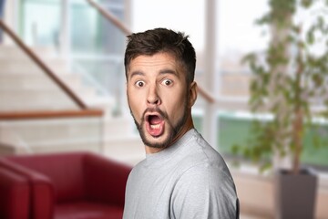 Fototapeta premium Surprised man posing on indoor background