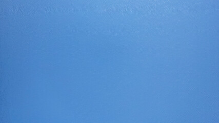 Top view of the blue surface of the lake water. A small ripple from the waves and a slight gradient from light blue to dark blue. Photo as a background. Clean water. Kolsai Lake, Kazakhstan