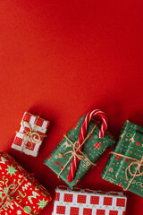 Christmas presents layout on red festive backdrop. Winter holidays concept