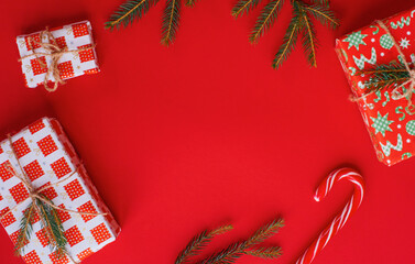 Christmas presents layout on red festive backdrop. Winter holidays concept