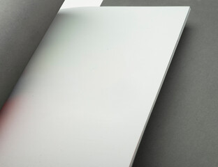 White paper brochure on gray paper background, you can write your text in white
