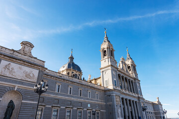 Fototapeta na wymiar Facade of the Almudena Cathedral (Catedral de Santa Maria la Real de la Almudena) in Madrid downtown, Spain, southern Europe. Neo-Romanesque, neo-Gothic and neo-Classical style, 1883-1993.