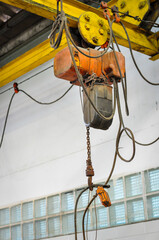 Electric crane to lift heavy objects used in the factory to produce goods.
