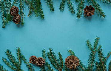 christmas background - pine tree branches and decor on blue copy space