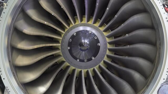 A close-up view of an aircraft jet engine turbine. 
Rotating turbine blades of turbo jet engine for plane. Аircraft concept, aviation and aerospace industry.
Large jet engine component detail.