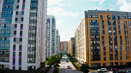 Fototapeta premium A bird's-eye view of the landscape. Stock footage.A city built up with tall houses with a highway outside the window where cars drive and courtyards where residents walk.