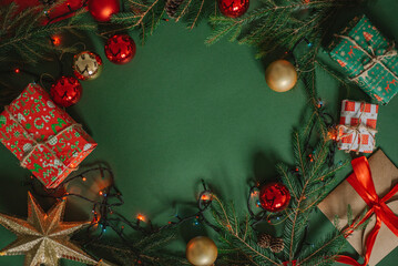 Christmas presents layout on green festive backdrop. Winter holidays concept