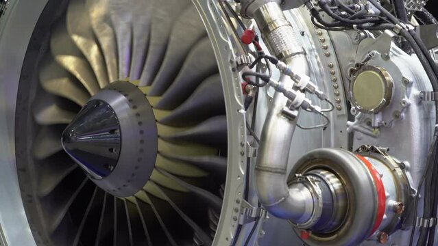 A close-up view of an aircraft jet engine turbine. 
Rotating turbine blades of turbo jet engine for plane. Аircraft concept, aviation and aerospace industry.
Large jet engine component detail.
