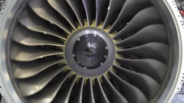 A close-up view of an aircraft jet engine turbine. 
Rotating turbine blades of turbo jet engine for plane. Аircraft concept, aviation and aerospace industry.
Large jet engine component detail.