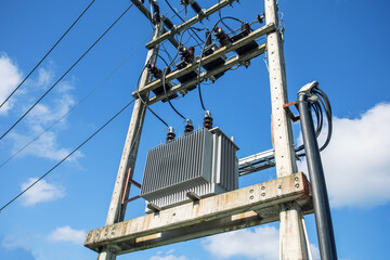 Electric transformer substation against the background of blue sky.