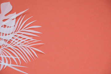 Tropical palm leaf on red background. Flat lay, top view	