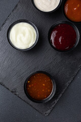 sauces of Asian cuisine on a black background
