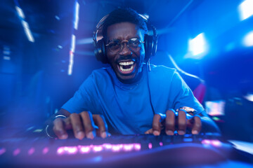 Happy American African Professional gamer, winner rejoices in victory of online games tournaments...