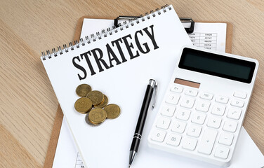 STRATEGY text with chart and calculator and coins , business concept