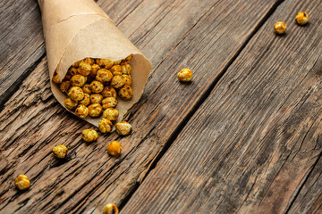 fried chickpeas on a dark background. Traditional Indian cuisine. Tasty vegetarian and vegan chickpea snack. banner, menu, recipe place for text, top view