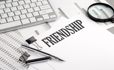 Fototapeta premium FRIENDSHIP text on paper with chart and keyboard, business concept