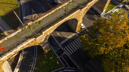 Aerial view at sunset of the Roman aqueduct crossing the Via Aurelia in Rome, Italy.