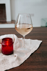 glass of wine on a table with a candle for a mockup 