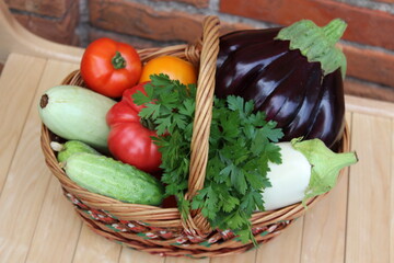 Basket with vegetables. Tomato, eggplant, cucumber, zucchini. Organic food.