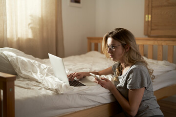 Caucasian woman using the laptop at home in morning