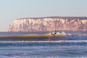 Surfers on Compton beach Isle of Wight at sundown