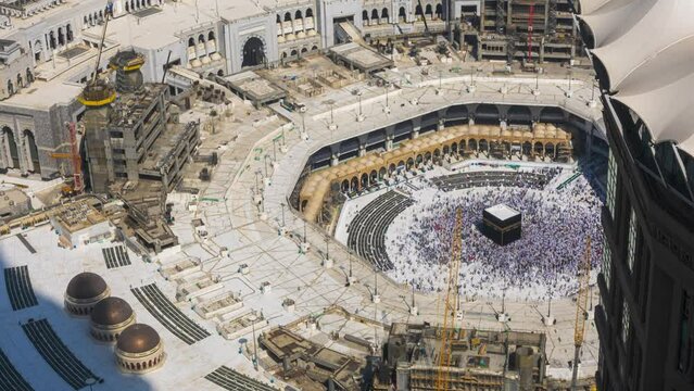 Time lapse of Muslim pilgrims circling around the holy Kaaba at noon and praying inside al Masjid al Haram in Mecca, Saudi Arabia.  Prores UHD Timelapse