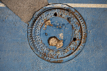 sewer manhole, scuffed coating with irregularities and roughness
