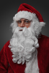 Shot of christmas santa claus with beard dressed in winter hat.