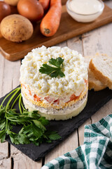 Russian salad or Olivier salad for Christmas dinner on wooden table