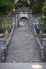 Fototapeta na wymiar massive entrance through the fortification wall into the gardens of the royal palace in Vietnam