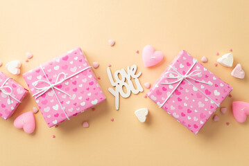 Valentine's Day concept. Top view photo of pink gift boxes inscription love you heart shaped marshmallow candles and sprinkles on isolated beige background