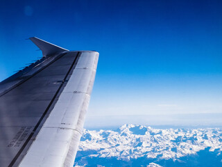 Aircraft wing and Alps from the plane window.