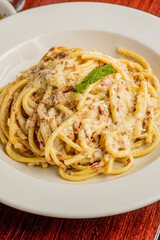 Spaghetti carbonara. Pasta with cured pork, cheese, egg, bacon, pepper and Italian parsley. Classic American or Italian restaurant favorite. Homemade pasta with butter sauce, meat and cheese.