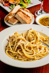 Spaghetti carbonara. Pasta with cured pork, cheese, egg, bacon, pepper and Italian parsley. Classic American or Italian restaurant favorite. Homemade pasta with butter sauce, meat and cheese.