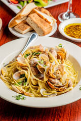 Pasta with clams. Pasta with clams and seafood, Parmesan cheese, spinach, and Italian parsley. Classic American or Italian restaurant favorite. Homemade pasta with tomato sauce, meats and cheeses.