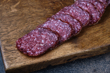 Traditional smoked salami sausage with spices.Salami sausage slices on a wooden chopping board