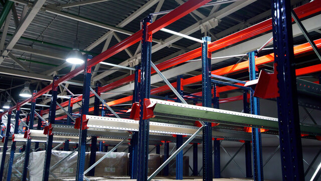 Warehouse, large logistics commerce structure. Creative. Large metal shelves at a modern warehouse, industrial warehouse on production plant.