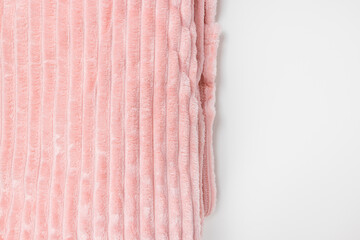 New folded pink throw fleece fabric on white background, closeup