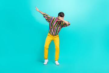 Fototapeta na wymiar Full body photo of young dancer guy wear vintage striped shirt yellow pants nice sneakers dab sign enjoy trend isolated on cyan color background
