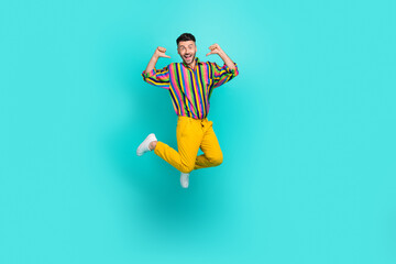 Fototapeta na wymiar Full length photo of funky jumping businessman wear striped colorful shirt fingers direct himself advert himself isolated on cyan color background