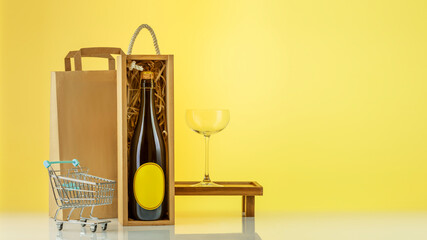 Eco friendly wine shop, wine bar winery or wine delivery concept. Mockup of bottle with champagne in a wooden box with wine glass, paper bag, shopping cart on yellow sunny background with copy space