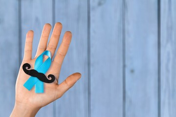 Fototapeta premium Prostate Cancer concept, hand holding Blue Ribbon