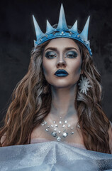 Shot of ice maiden with make up dressed in crown and cloak.