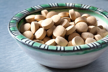 Detail of some brewer's yeast tablets in a ceramic bowl