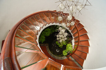 Spiral stairs with hanging lamp in the middle
