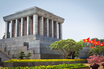 communist flag of Vietnam fluttering on the background of the mausoleum of Ho Chi Minh